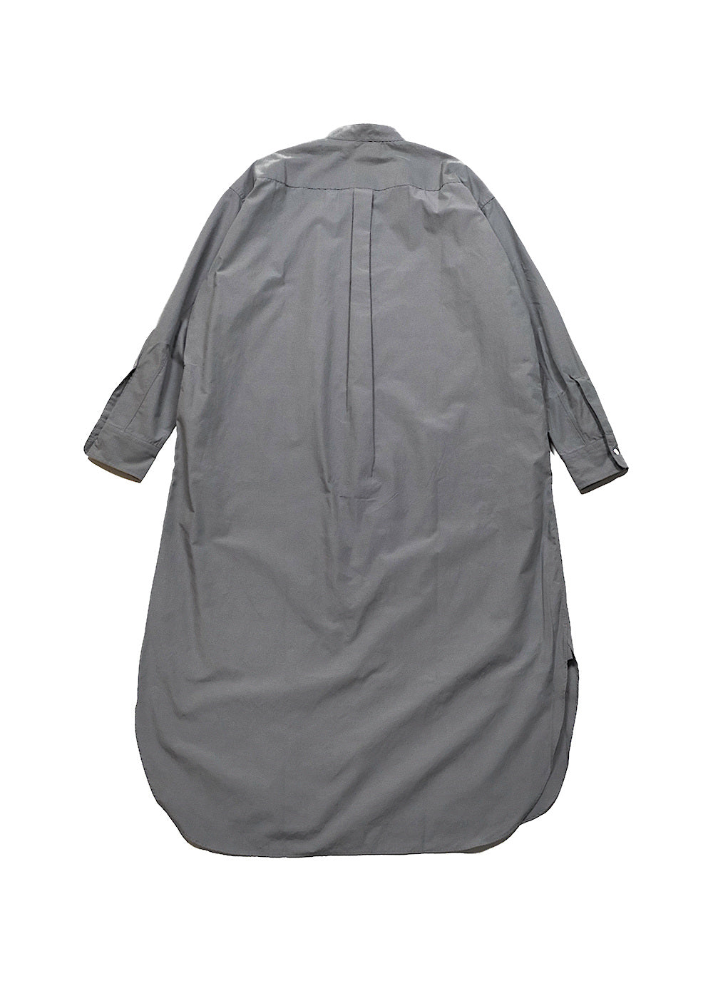 A gray oversized long-sleeve shirt dress shown from the back, featuring a central pleat and buttoned cuffs, laid flat against a white background.